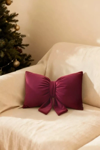 Pernă cu fundiță de Crăciun de la Needle and Thread – pernă din catifea bordo, certificată Oeko-Tex